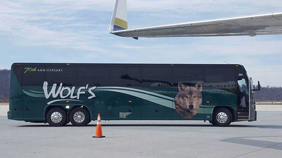 Wolf's bus parked by airplane